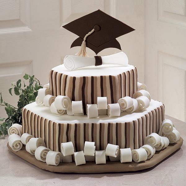 Honor Roll Scroll Graduation Cake. Without too many bright colors, this amazing graduation cake features the big cap at the top, diploma and curls as well as attached side strips in simple colors for a school flavor.