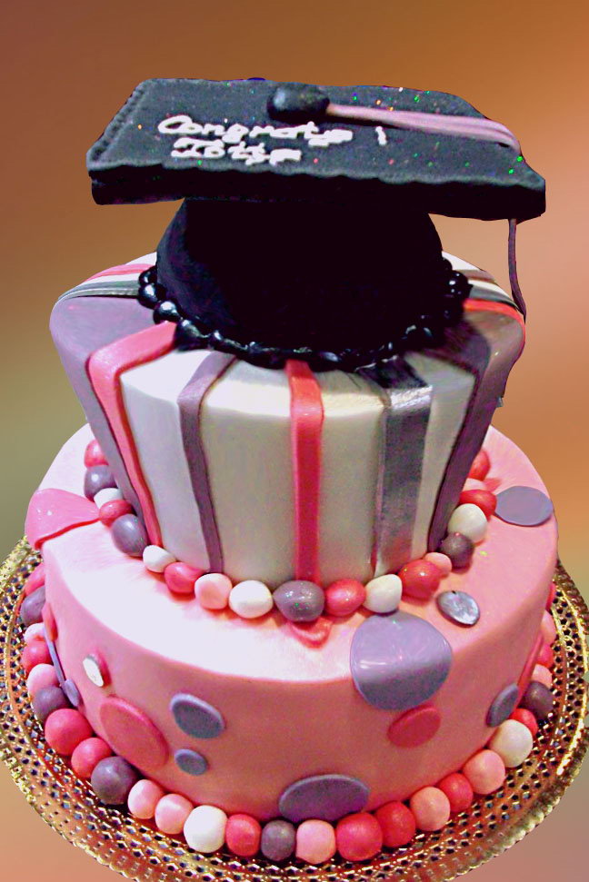Sweet Graduation Cake. This sweet graduation cake features a big graduation cap at the top. It has strips, polka dots as well as colorful candy balls at side for beautiful garnishment. This graduation cake is super fantastic for a girl.