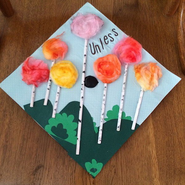 Floral Design Graduation Cap. Glue green grasslands on the cap board. Glue paper rolls and pomp pomps in bright colors  to create the delicate floral shape.