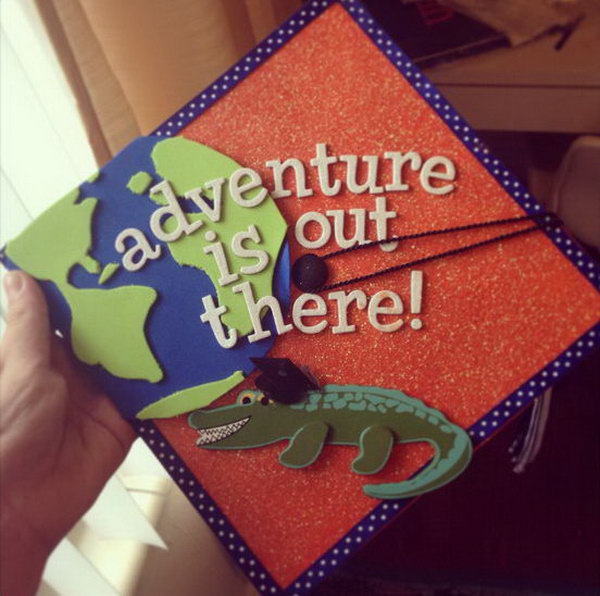 Travel Inspired Graduation Cap. This stunning graduation cap features a crocodile wearing a graduation cap. There is also a part of the globe above it. Start your adventure with this cool cap after graduation.