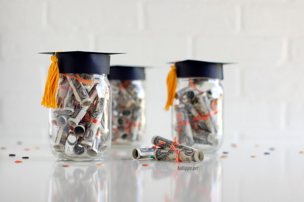 Mason Jar Graduation Cap. Create the lid of the Mason jar to make the graduation cap. Roll up bills in a diploma style and add the twine to tie the bow. The graduate must be very pleased to receive this graduation cap Mason jar filled with bills.