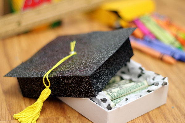 Cash Diploma. Congratulate to the graduate's academic achievement with this funny cash gift. It features a plain box in a glittering black graduation cap. You can fill it with rolls of money in diploma style as you like.