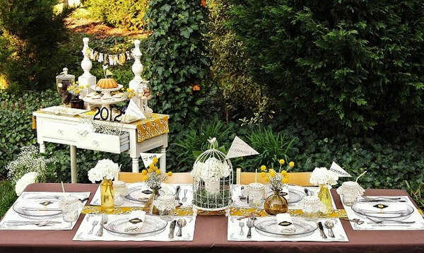Key to Success Theme. To bring out the key to success theme to the table design, place keys and key holes around the table. The pennants attached to wooden skewers and inserted into the floral arrangements bring a collegiate element for the celebration.