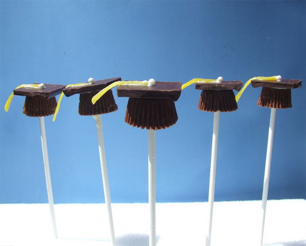 Graduation Dessert Idea. Stand apart your own party with the rest by these adorable candy graduation candy caps. Place Reece’s cups on wax paper, insert lollipop sticks into the cup. Top the cup with square chocolate, glue candy belt and rainbow chip.