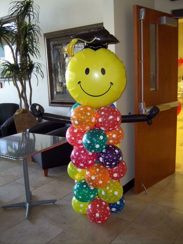 Graduation Balloon Decor. This graduation person made out of balloon is really stunning and eye-catching. All you need is to put colorful balloons of various shapes together.