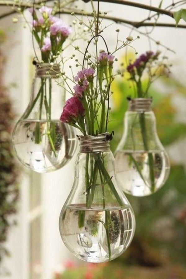 Use old bulbs as vases. The bulb vase with beautiful flowers looks like a crystal ball. What a cool decoration idea.