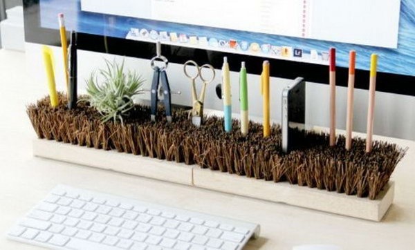 An organized desk will give you an organized mind and a good mood, so get yours in order by just inverting a broom head to store most of the junk on your tabletop, like pens and office stationery, and even create a cool charger dock for your smartphone. 