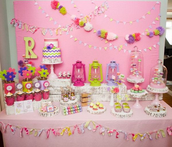 Glam Camping Party. The tassel and pom banner on the backdrop set up the tone for this party. With the glass jars for trail mix, polka dot balloons, lanterns, camp ricki pillowcases décor, it make this camping party an exciting project for you to follow.