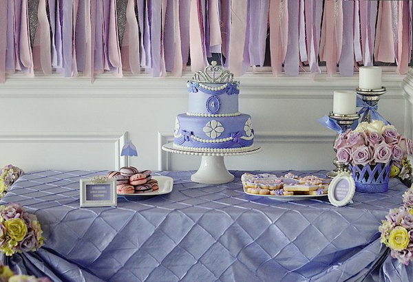 Sofia Inspired Princess Party. The dessert table backdrop, the glittering princess crown banners, princess dress food toppers and many other favors add up the romantic lavender flavor.