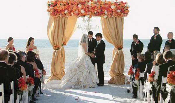 Floral Wedding Canopy. This enchanting canopy is super chic for a sand beach wedding with flowers limited to the top of your canopy for a romantic setup.