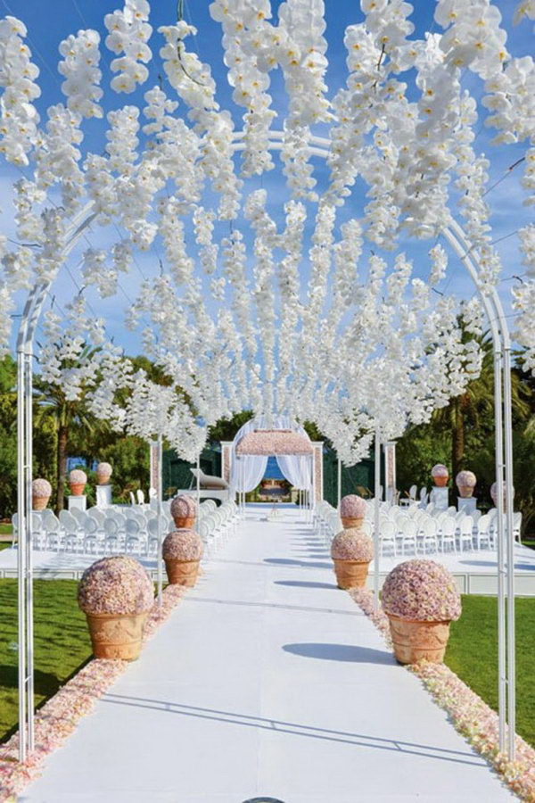 Orchid Archway. Nothing gets more ethereal than this orchid-covered archway for your outdoor wedding decor. It seems as if the petals are magically floating in thin air. 