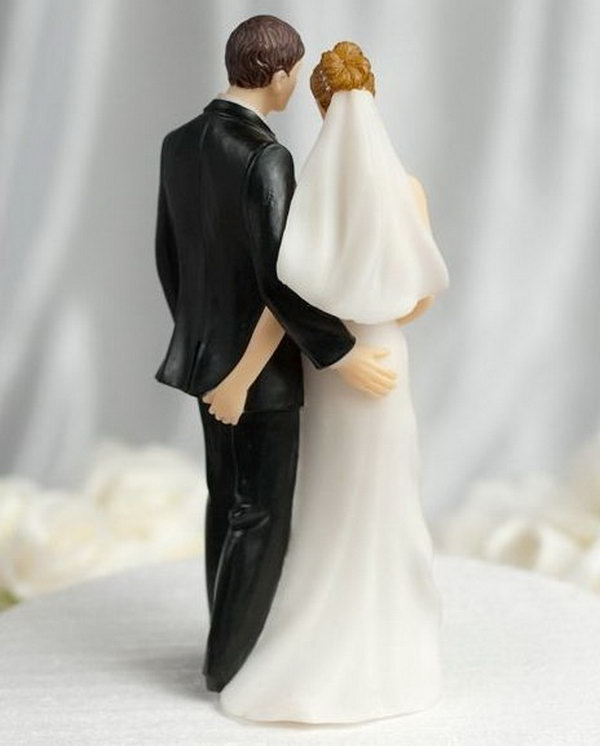 Funny Cake Topper. The bride and groom stand there innocently; however, from behind they are secretly giving each other a 'tender touch'. This funny sexy cake is sure to be a conversation piece at your wedding. 