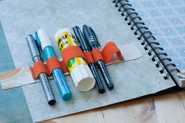 Supply Holder Notebook. Stick a pocket and fill it with journaling pieces. Secure orange elastic on the outside cover with a set of towels to make it more applicable to keep your essentials tidy.