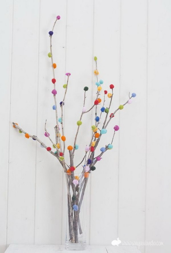 Pom-pom Branch Bouquet. Use the glue gun to secure colorful pom-poms on the branch in a beautiful display. Insert in a flower vase for beautiful decor with low cost.