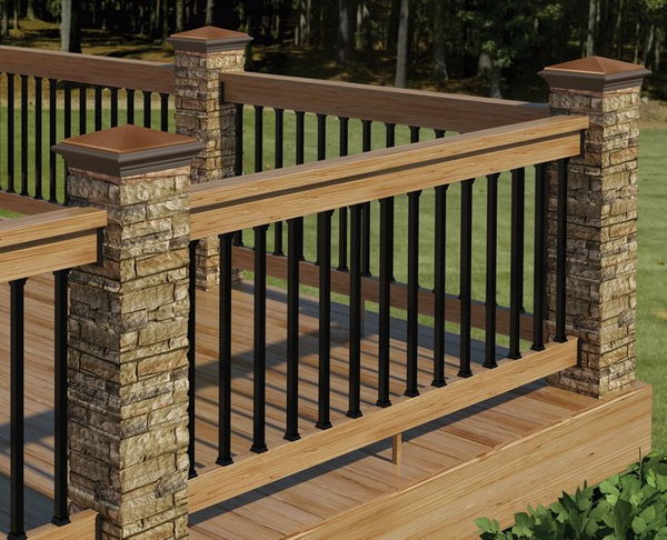 Stone, metal and wood deck railing. This deck railing has a wooden top with horizontal metal rails and big stone pillars and it's very sturdy and low maintenance . The color theme coordinates perfectly with the composite decking. What an attractive, warm and inviting outdoor living space. 