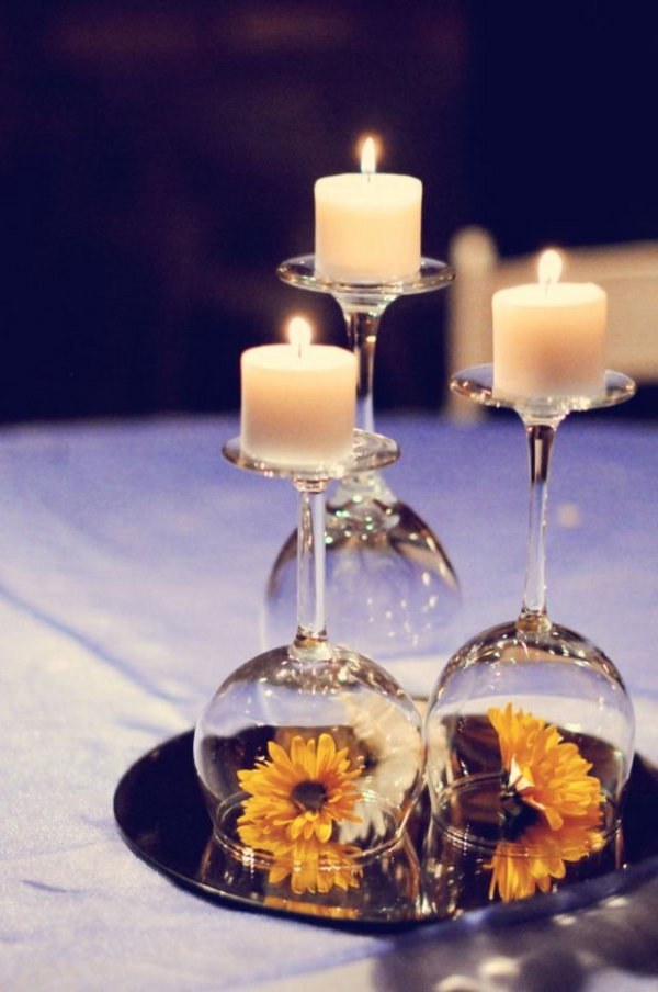  Mirror used as a table centerpiece in the wedding. This table centerpiece must be an impressive feature with mixture of candles, mirror, wine glasses and colorful flowers on the table in the wedding. 