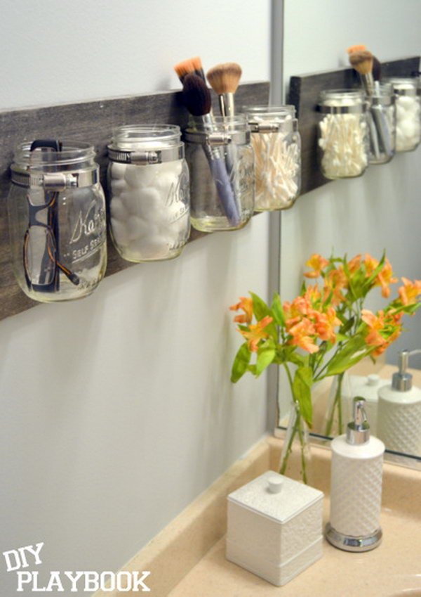  DIY Mason jar makeup holder. Decorate the Mason jars and attach them to a wood board like this one as a creative and amazing storage of your makeup.