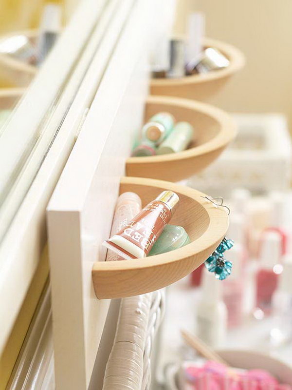 Use the wooden bowls bought from a dollar store cut in half and painted boards  to make these cute and beautiful wall pockets as  makeup storages. Of course, the size of the wall is up to you. 