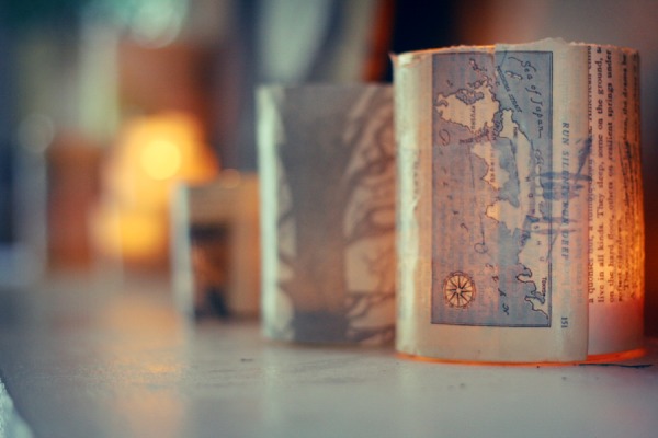 Map Votive. Rinse out jars and remove labels, glue map pages onto jars with mod-podge, place candles inside to finish off this piece or art to offer a beautiful decor especially for your dinner party.