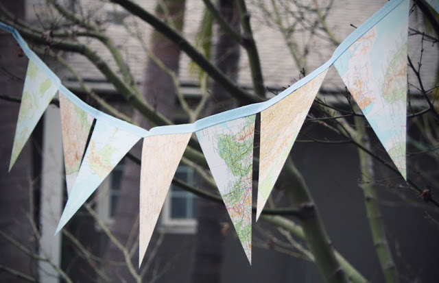 Map Bunting. Glue map triangle on the thick cardstock. Attach bias tape to both sides of the triangle, use a zig-zag stitch to sew it up to from a loop for hanging the bunting. This serves as a perfect outdoor decor with the travelling map theme.
