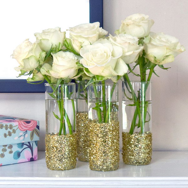 DIY Glitter Shot-Glass Vases. These glitter and sparkling shot glass vases with some fresh flowers in are sure to wow your guests as the table accessories for any outdoor entertainment or wedding. See more details here.