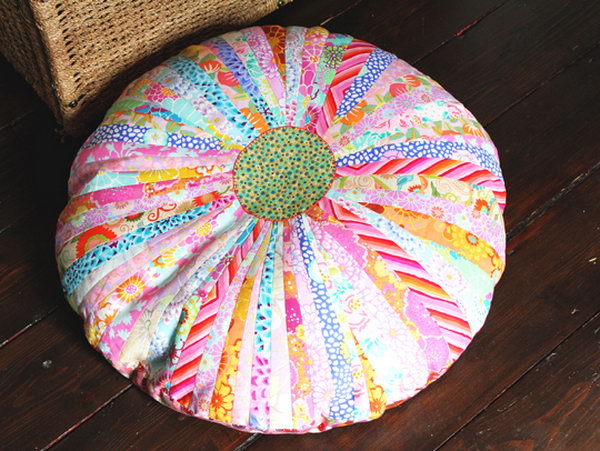 Beautiful DIY Floor Cushion. Join strips of the fabric with beautiful pattern in bright color, press the seams. Place a contrasting fabric in the center to make the cushion top look like a pretty flower.
