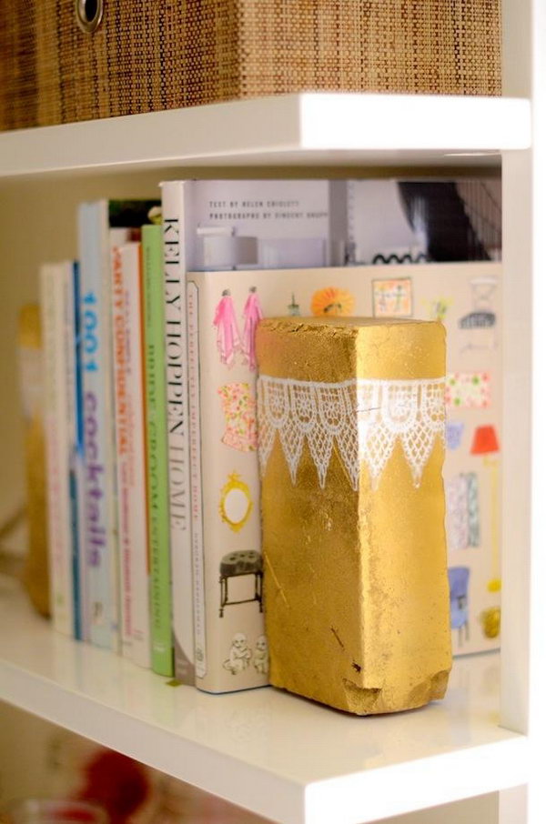 Brick Book Ends. Spray paint to add the gold color for the brick, decorate it with trims of lace or other fabric for a glamorous, feminine outlook to add up the beauty for the decoration of girls' dorm room.