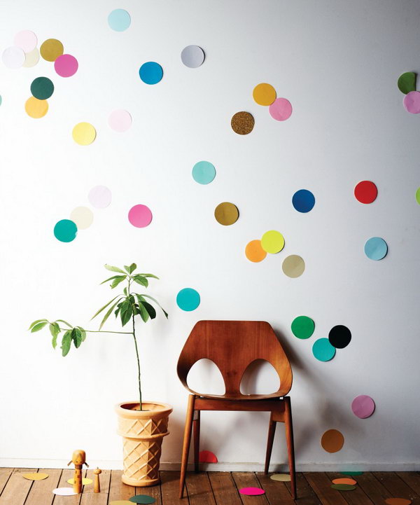 Giant Confetti Wall. Gather a pile of colorful paper, cut all circles out. Glue on the back and arrange all the circles to your imagination to design the beautiful decor for girls' dorm room with various colors.