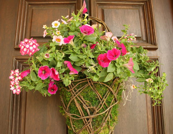 Easy Front Porch Moss Basket. Fill the moss basket either with dried stems or fresh flowers. Stuff the basket to completely cover the part that you see from the front of the basket. Just insert half of the flowers in to the last top third of basket for a beautiful rustic design for May.