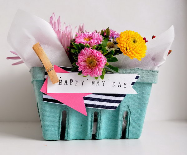 Berry Basket May Bouquet. Line each basket with a sheet of parchment and nestled in mason jars. Fill the mason jars with flower and water. Pin a few embellishments to finish off the beautiful outlook for May.