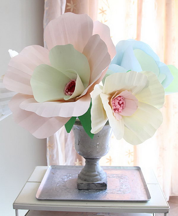 Giant Paper Flower Bouquet Centerpiece. Cut slits in petals by tracing the template and assemble them together to form a cup shape. Arrange and glue petals together. Glue flower and leaves to the dowel. Everyone will enjoy this brilliant piece of art in May.