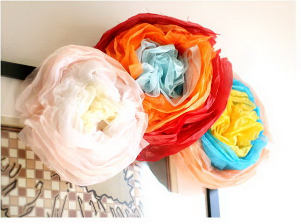 DIY Festive Paper Flower. Fold the stack of tissue paper of 3 colors. Staple the center part to secure. Scrunch it up to form circular curves to form the flower petal shape. It's super chic to arrange them as a beautiful bouquet for decoration display in May to impress all your friends and relatives.