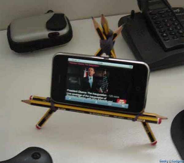 Pencil iPhone Stand. Strap two pencils together with elastic band to make the horizontal support, use more pencils to create a triangle and add one more for back support. It's easy yet very helpful to place your iPhone.