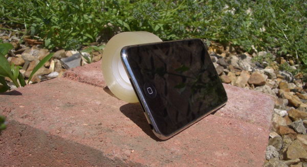 Sticky Tape Stand. For those who would like to create a simple stand in within ten minutes to enjoy the movies at a perfect angle, this one would be the perfect choice. Just stick a bit of tape to the back of you iPhone device then you can sit and enjoy.