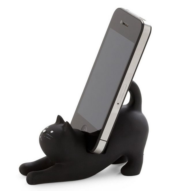 Charming Black Cat iPhone Stand. This functional cat stand can hold your smartphone upright with a notch on its back and cute curled tail to display your device in a playful and funny way.