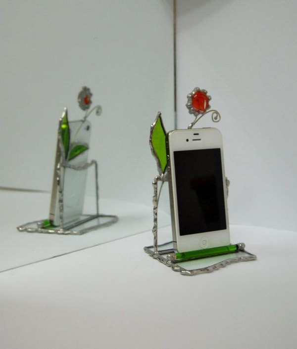 Stained Glass iPhone Stand. This stained glass stand for iPhone made by transparent glass and decorated with green glass leaves and red glass flower on adjustable wire is perfect to display your iPhone in an elegant way.