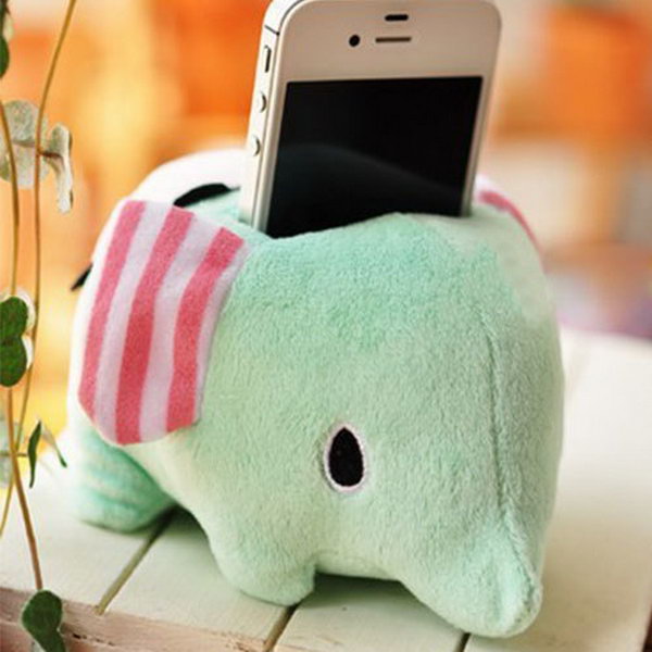 Cute Sweet Plush Elephant iPhone Stand. This plush holder features adorable cartoon elephant shape.  It's perfect to display your iPhone device with this beloved stand in warm-toned color.