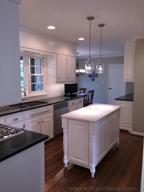  Small white traditional kitchen. The island was beautifully made and looks very elegant. The integrated island feet add a traditional feel to this piece. The island paint color is also Benjamin Moore OC-17 White Dove.
