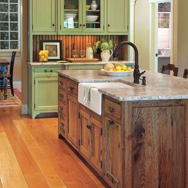  Old country farm look kitchen. The vintage wood tone island add a farm look to this green kitchen. And the black sink on the top would really make island colors flow.