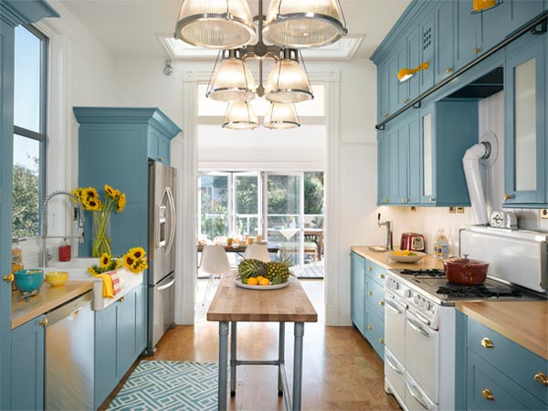  Bright kitchen. Opened up to the sun, the galley kitchen is now blue and white and bright all over, with an existing vintage Wedgewood stove as its centerpiece. 