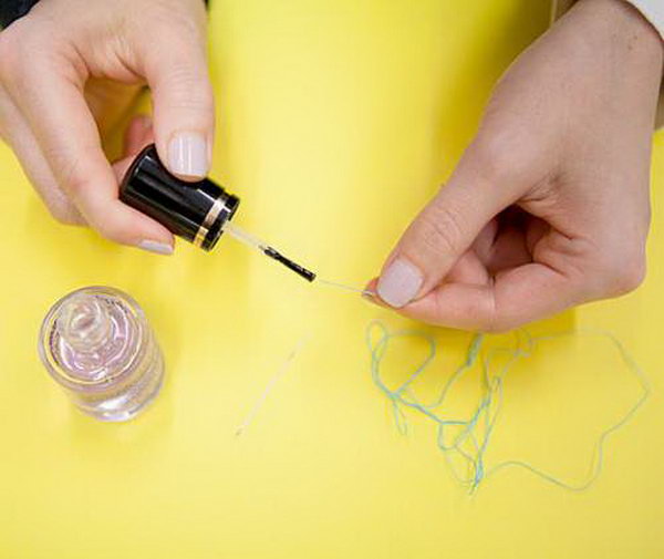 Use clear polish to thread a needle more easily.  Sometimes it's so hard to pull through  a needle. But if you coat the end of the thread with a dot of nail polish, it will be easier to slide through like silk. 