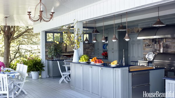 Plain and fancy cabinets with Nantucket-style doors and blue-toned Caesar stone on top plus the colors of water. It is a great place for cooking and holding a party during summer. 