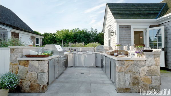 The U-shaped layout of this Nantucket kitchen is zoned from hot to cold. All of the appliances and the stainless-steel cabinetry are designed to be weather-tight. 