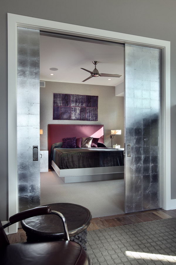 Master Bedroom With Oversized Silver Leaf Pocket Doors 