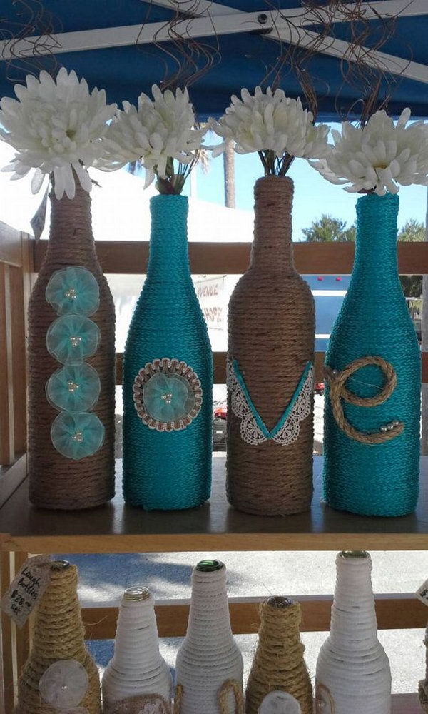 Upcycled Rope-wrapped Wine Bottles as a wedding Decor. These adorable rope-wrapped wine bottles with the letters to spell LOVE are wonderful for a wedding with flowers in. 