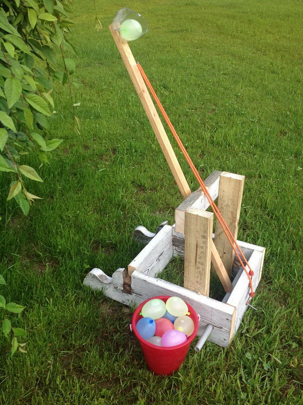 Water Balloon Catapult Launcher. Secure the bottom part of the soda bottle at the end of the wooden catapult and fasten it with the rubber band. Use the bottle to display your water balloon. Just release the band, aim and fire your water balloon. So exciting.