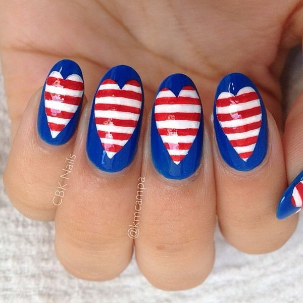 4th of July Love Nail Art: This design is a funky take on flag-inspired nails. Start with a navy blue base and heart middle. Then freehand-paint the white and red stripes using a nail art brush. I love the American heart so much. 