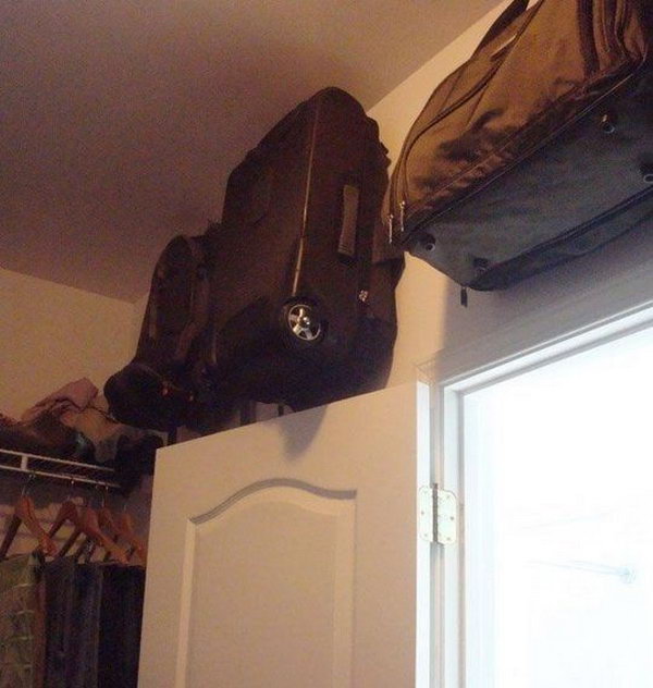 Store Suitcase in the Space above the Closet Door on Hooks 