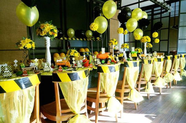 Construction Party Decoration: Look at the awesome construction sign chair ties and the yellow and black balloons, they are so fitting and fun for the construction theme. 