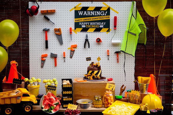 Construction Themed Birthday Decoration: Green, orange and yellow color construction themed birthday decoration. I love the tools attached to the white board as an accent wall.